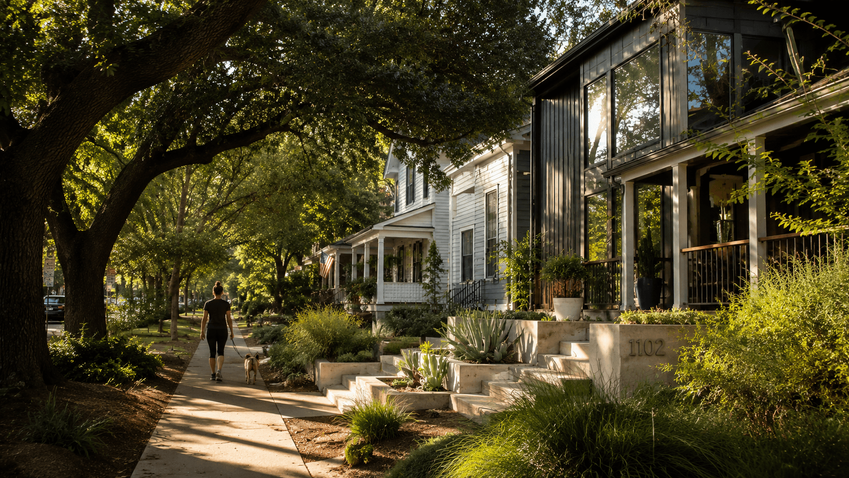 A walkable Austin neighborhood street with mature oaks and a craftsman home