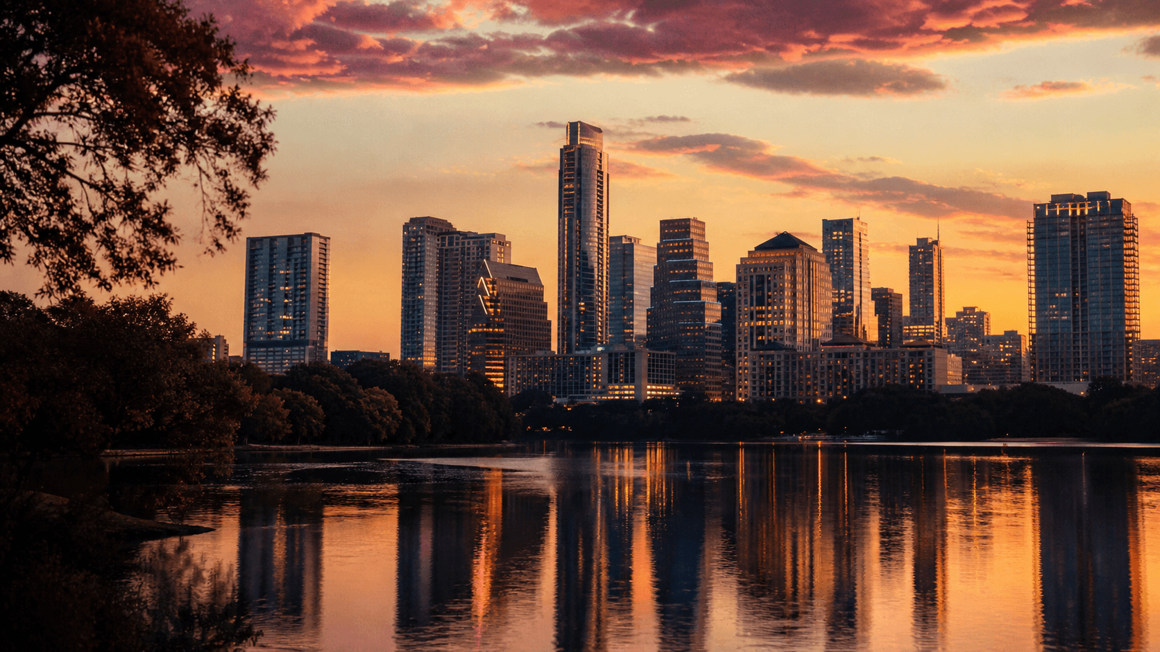 Cinematic view of Austin skyline at dusk with Lady Bird Lake in the foreground