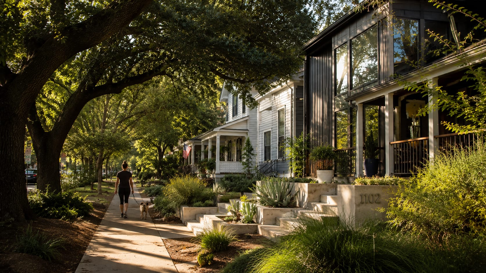 A walkable Austin neighborhood street with mature oaks and a craftsman home